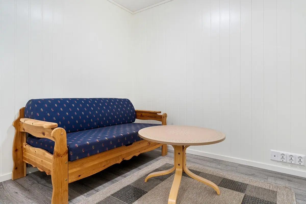 Felles oppholdsrom med sofa og stuebord